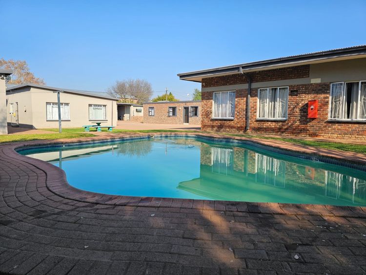 The pool at Nguni with the brick units reflected in the water